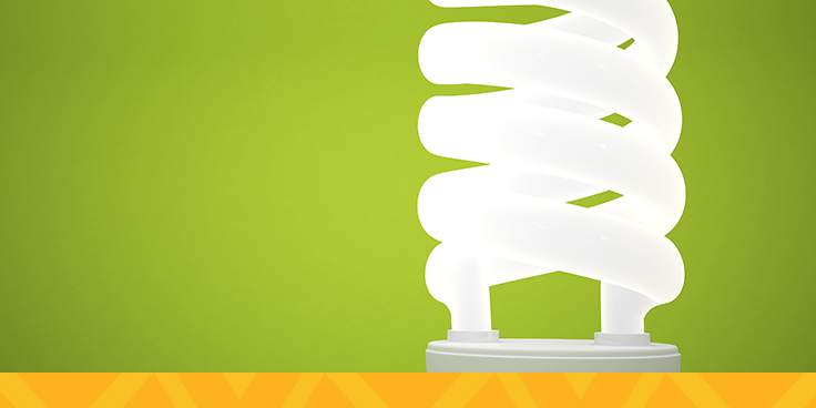 energy efficient light bulb against green background